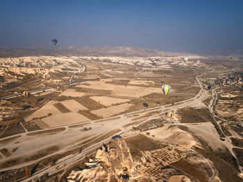 Aerial view of hot air balloon flying over landscape