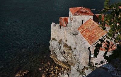 High angle view of buildings by sea