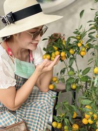 Low section of woman holding fruit 