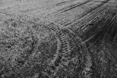 High angle view of tire tracks on sand