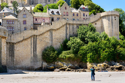 Low angle view of old town with defensive wall.