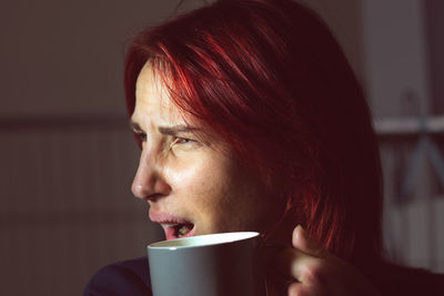 Girl wit morning coffee tea portrait close up red hair
