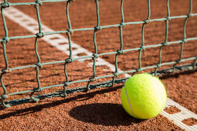 Green ball on tennis field