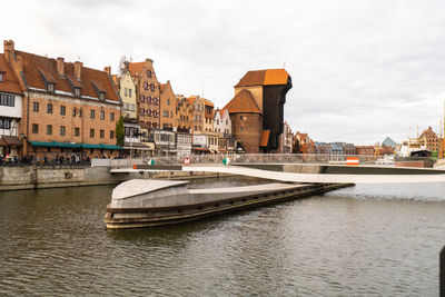 New modern bridge turning in old town in gdansk. opening of a revolving footbridge, granary island