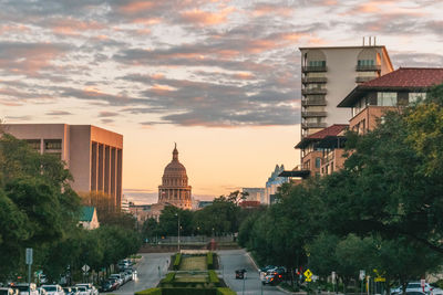 Buildings in city against sky during sunset