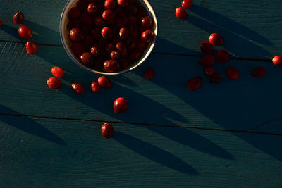 Directly above shot of red fruits on wooden table