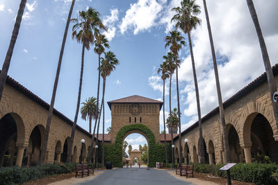 Arched built structure with ivy and clock at stanford university campus