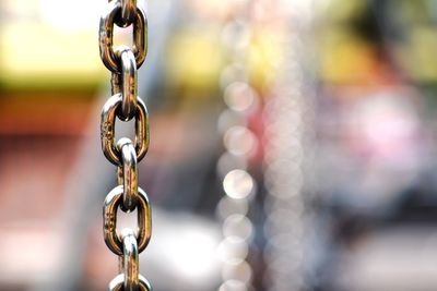 Close-up of metallic chain hanging outdoors