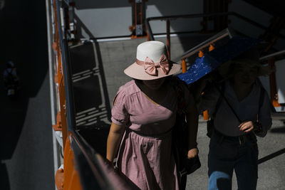 Two women walking on staircase