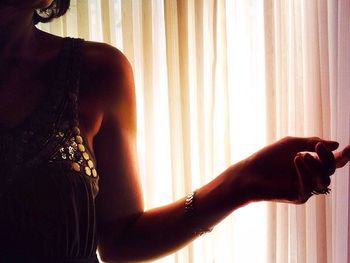 Close-up of woman looking through window