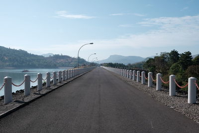 View of bridge over calm sea against sky