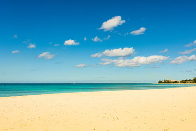 Scenic view of beach against blue sky