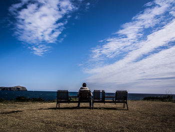 Lifeguard hut on beach against blue sky