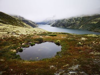 Scenic view of lake and mountains against sky