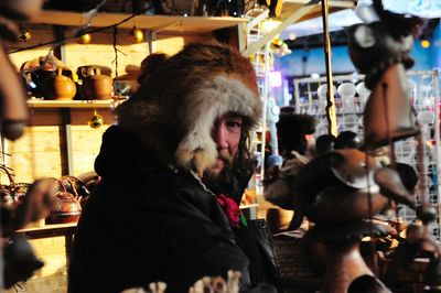 Portrait of man wearing fur coat in store