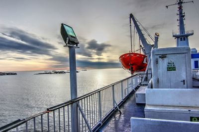 Ship sailing on sea against sky during sunset