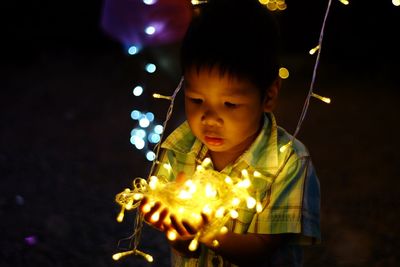 Boy looking at illuminated christmas lights