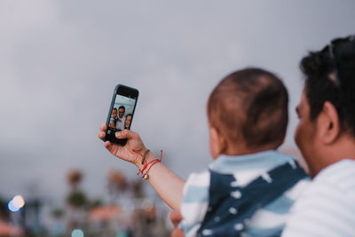 Man photographing with mobile phone