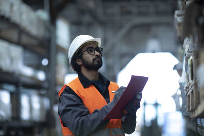 Young store worker controlling ware