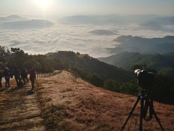 Rear view of people photographing mountains