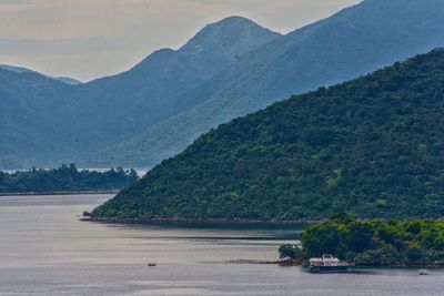 Scenic view of bay against mountains