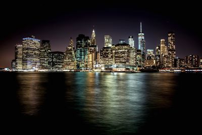 Illuminated city at waterfront