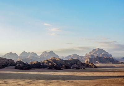 Scenic view of sea and mountains against sky