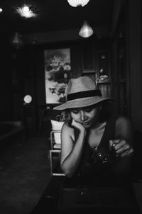 Young woman pouring tea in cup