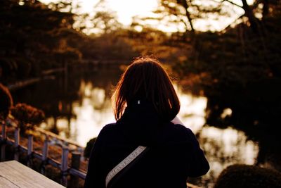 Rear view of woman standing in park