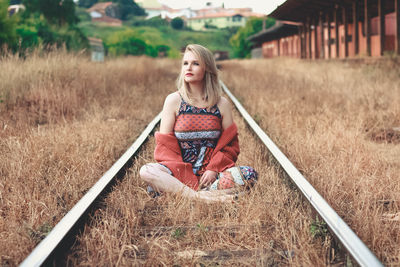 Portrait of woman sitting on field