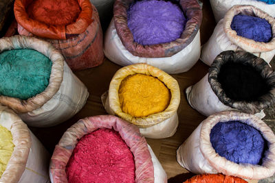 High angle view of colorful powder paints for sale at market