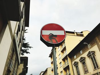 Low angle view of road sign against sky