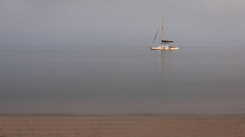 Sailboat on sea against sky