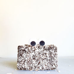 Close-up of cake on table against white background