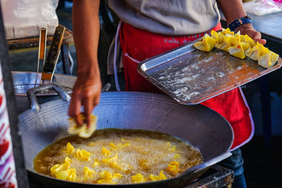 Midsection of man preparing food