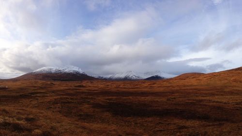 Scenic view of arid landscape against sky