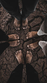 Low section of people standing on pebbles