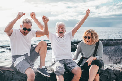 Group of friends sitting at beach