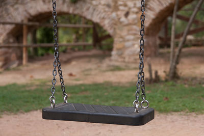 Close-up of empty swing in park