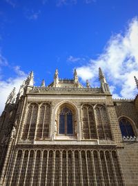 Low angle view of building against cloudy sky