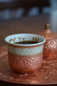 Close-up of coffee cup on table