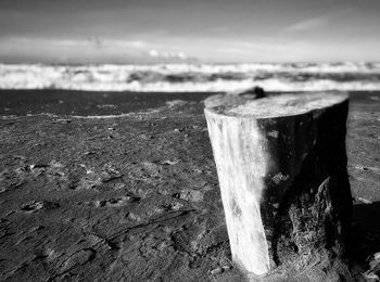 Close-up of water on beach against sky