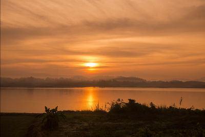 Scenic view of lake against sky during sunset