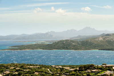 Scenic view of sea and mountains against sky