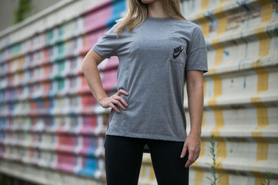 Full length rear view of woman standing in front of office