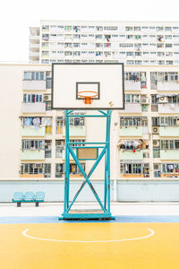 Low angle view of basketball hoop against buildings in city