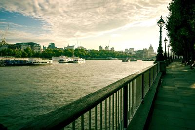 Scenic view of river against sky in city