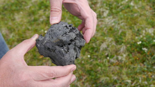 Close-up of person holding stone