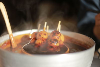 Close-up of burning candle in plate