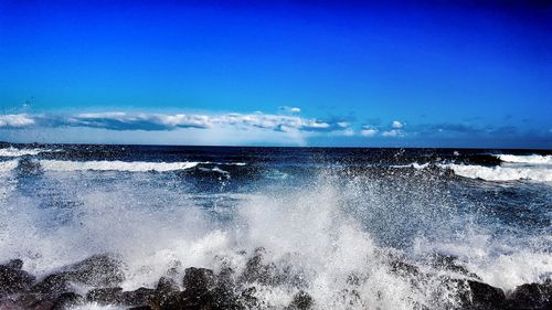 Scenic view of sea against clear blue sky